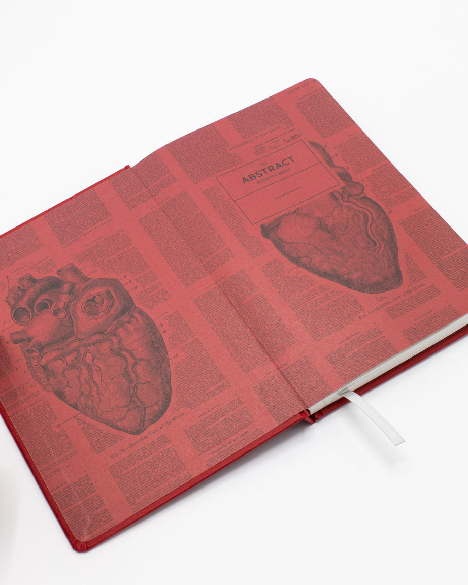 A red Cognitive Surplus Heart A5 Hardcover Notebook - Dotted Lines with an image of a heart and a cup of coffee.