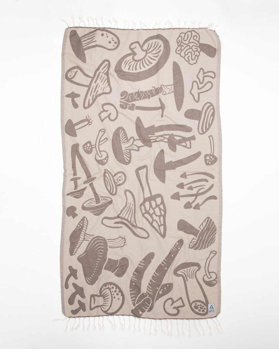 A beige Edible & Poisonous Mushrooms Turkish Towel by Cognitive Surplus with a variety of mushrooms on it.
