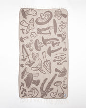 A beige Edible & Poisonous Mushrooms Turkish Towel by Cognitive Surplus with a variety of mushrooms on it.
