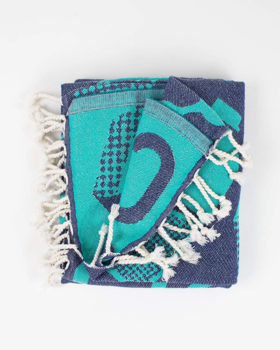A blue and green Lab Science Turkish Towel with tassels on it from Cognitive Surplus.