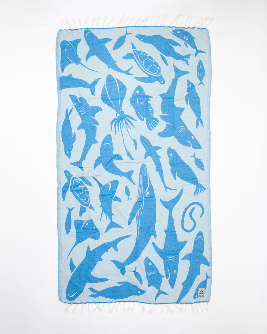 An Ocean Explorer Turkish Towel with sharks and fish on it from Cognitive Surplus.
