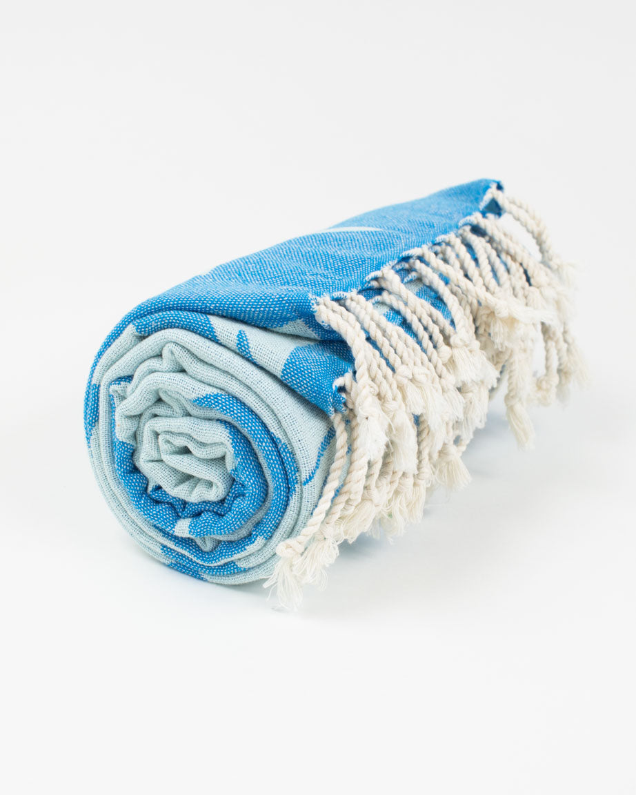 An Ocean Explorer Turkish Towel by Cognitive Surplus with fringes.