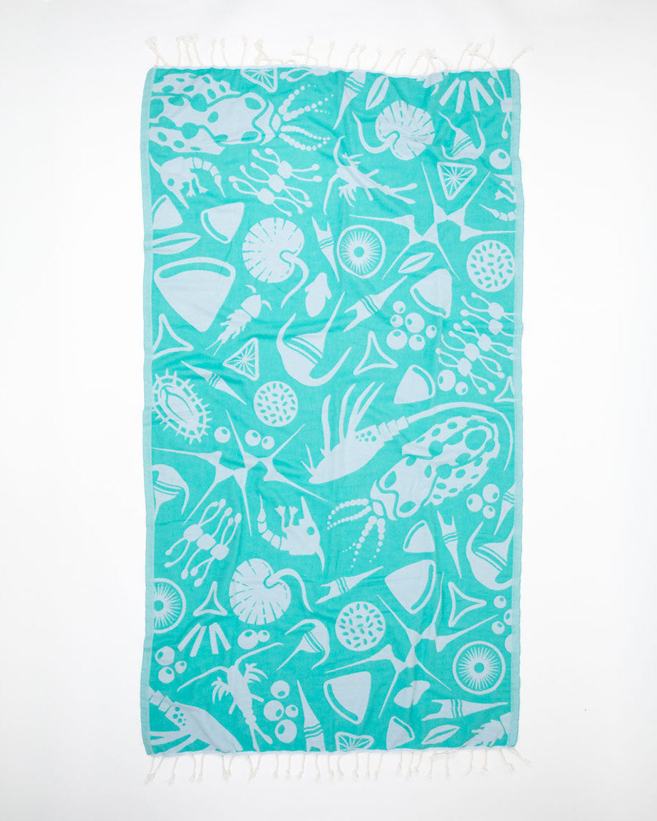 A Go With the Flow: Plankton Turkish Towel by Cognitive Surplus with a pattern of fish and shells.