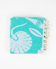 A Go With the Flow: Plankton Turkish Towel by Cognitive Surplus with palm leaves on it.
