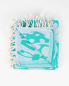 A Go With the Flow: Plankton Turkish Towel by Cognitive Surplus, in turquoise and white with tassels on it.