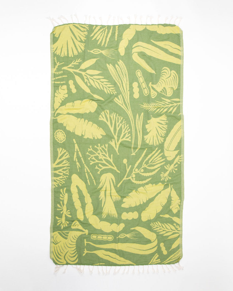 A Seaweed Turkish towel with yellow and green plants on it from Cognitive Surplus.