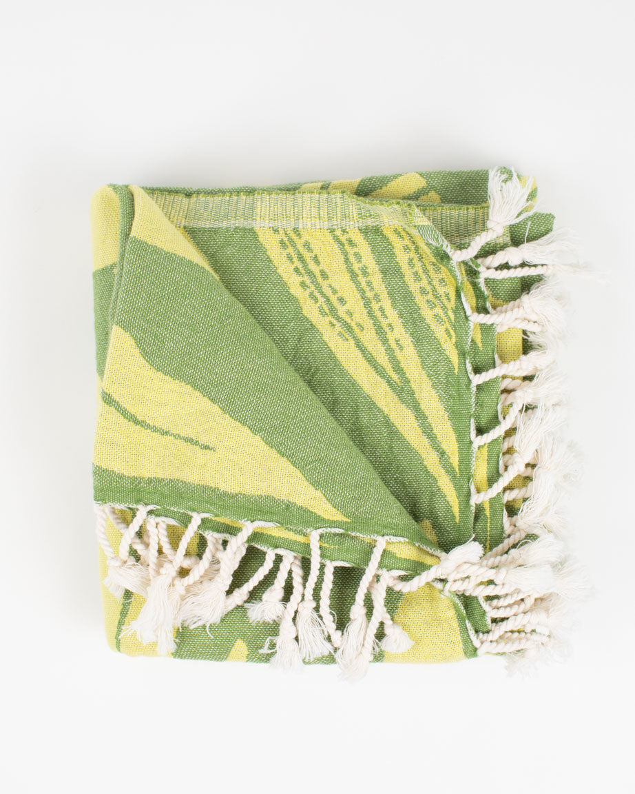 A green and white Seaweed Turkish Towel with fringes by Cognitive Surplus.