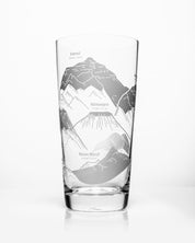 A SECONDS: Mountain Peaks of the World Beer Glass (12 oz) by Cognitive Surplus with mountains engraved on it.