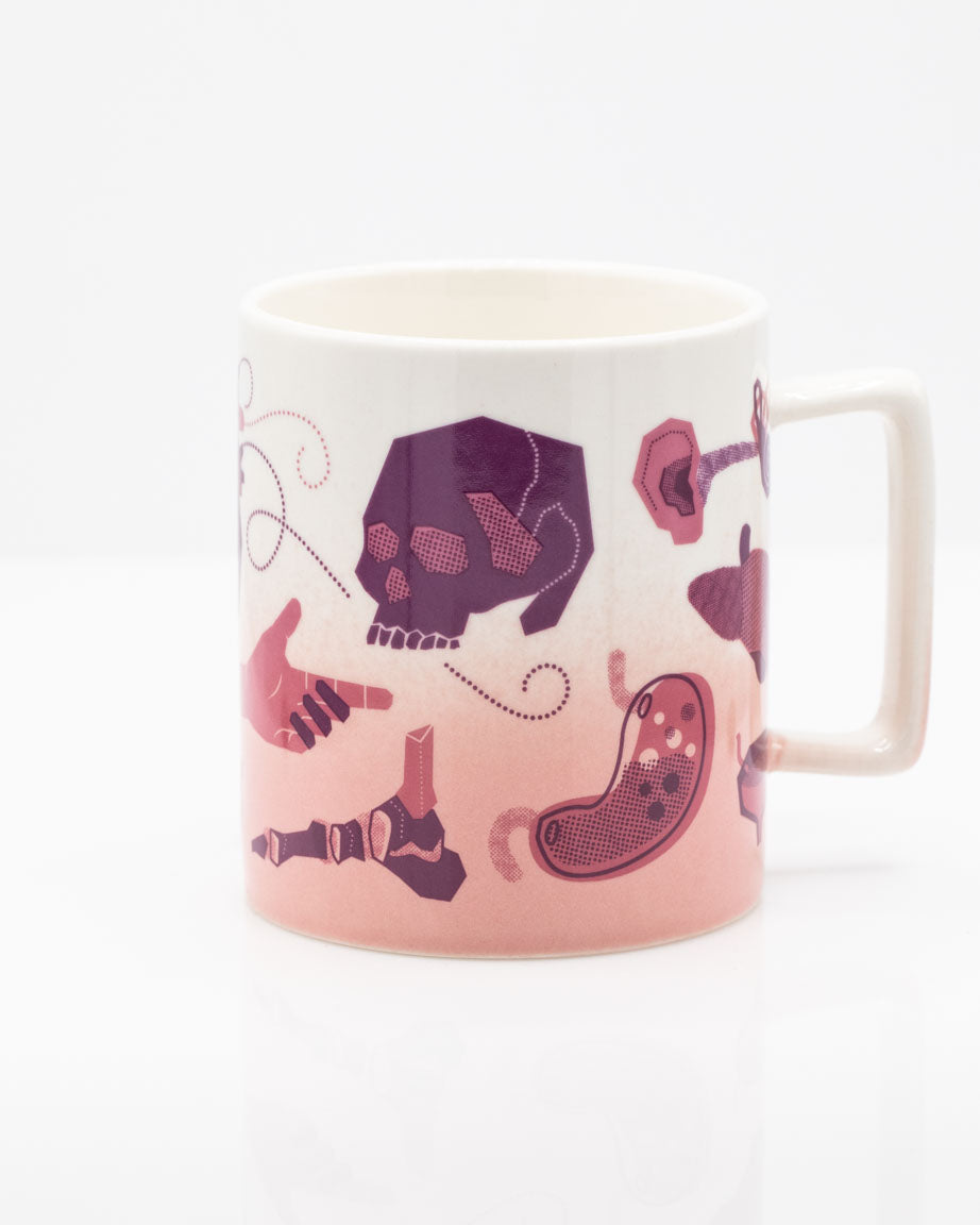 A Retro Anatomy 11 oz Ceramic Mug by Cognitive Surplus with a skull and other things on it.