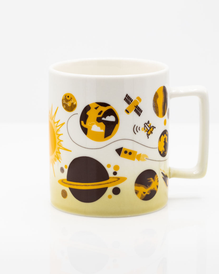 A Cognitive Surplus Retro Space 11 oz Ceramic Mug with a space themed design on it.
