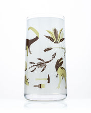A Retro Paleontology Drinking Glass with dinosaurs and plants on it from Cognitive Surplus.