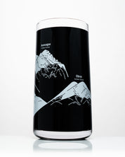 A black Mountain Peaks of the World Drinking Glass with a map of the mountains on it by Cognitive Surplus.