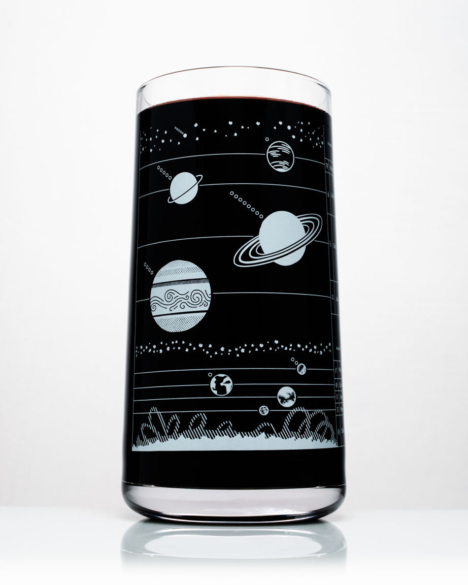 A Cognitive Surplus Solar System Drinking Glass with planets and stars on it.