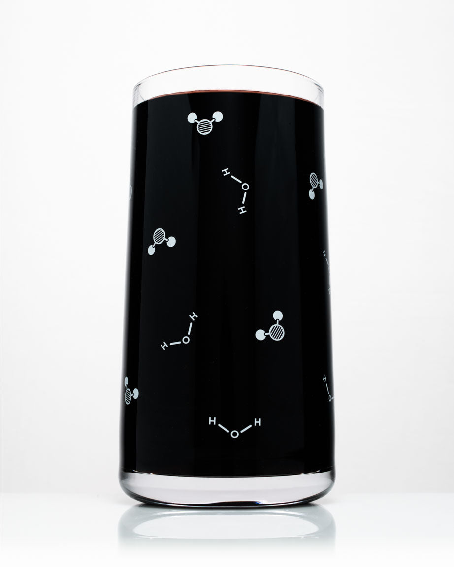 A Cognitive Surplus Water Chemistry Drinking Glass with atoms and molecules on it.