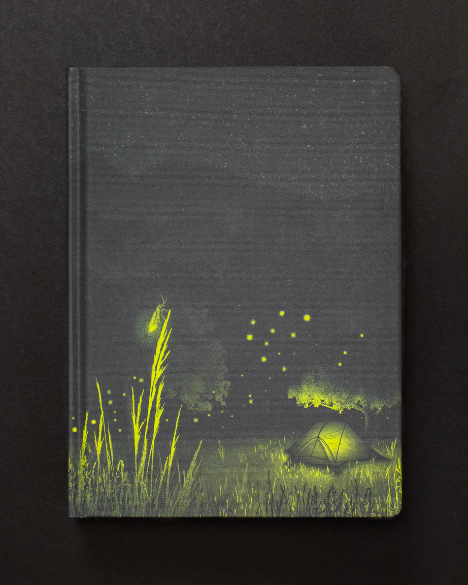 A Firefly Meadow Dark Matter Notebook with a tent and fireflies on it by Cognitive Surplus.