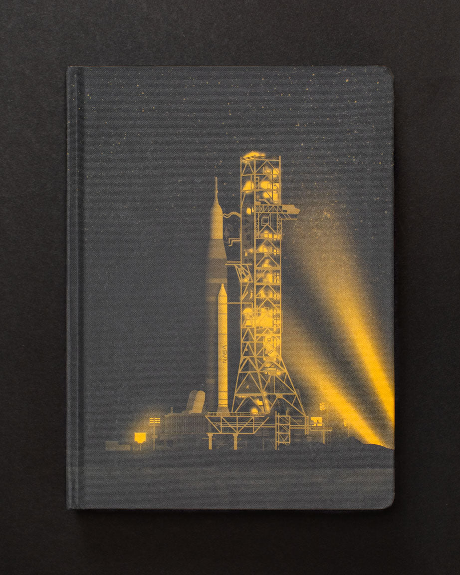 A Ready to Launch Dark Matter Notebook by Cognitive Surplus with an image of a rocket on it.