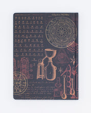 A Cognitive Surplus Alchemy Hardcover Notebook - Lined/Grid with a black cover and various objects on it.