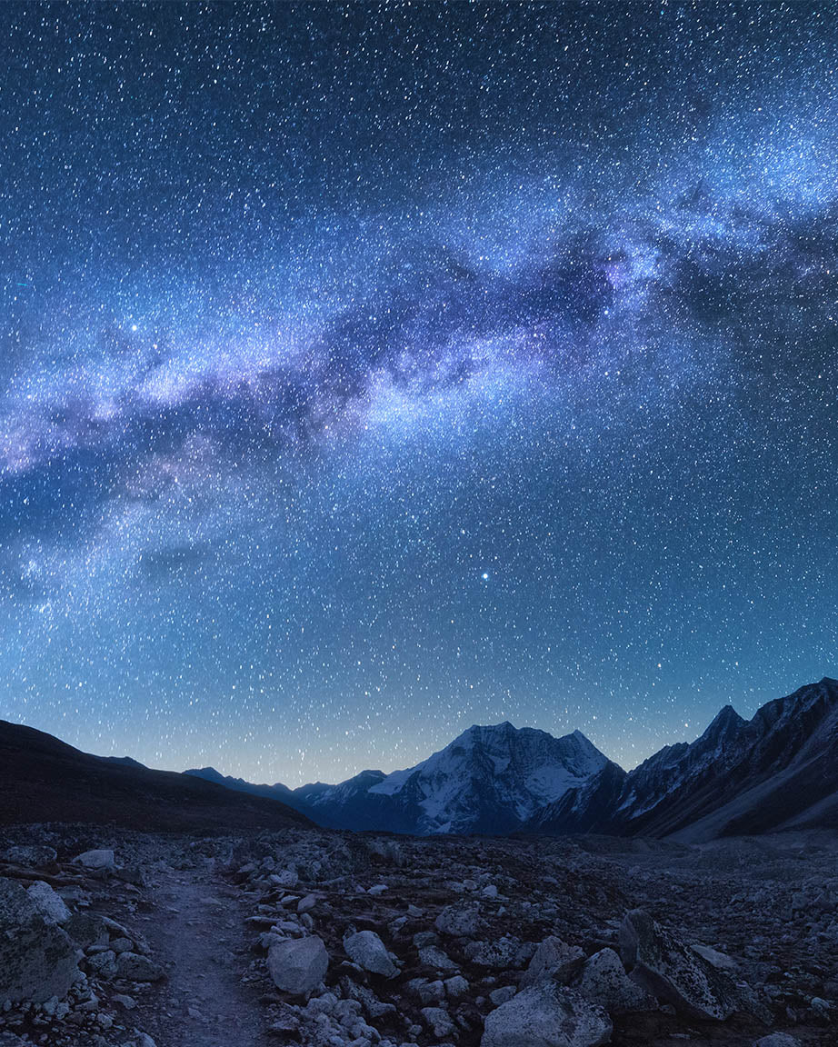 The Mysteries of the Milky Way Pack in the sky above a mountain path.