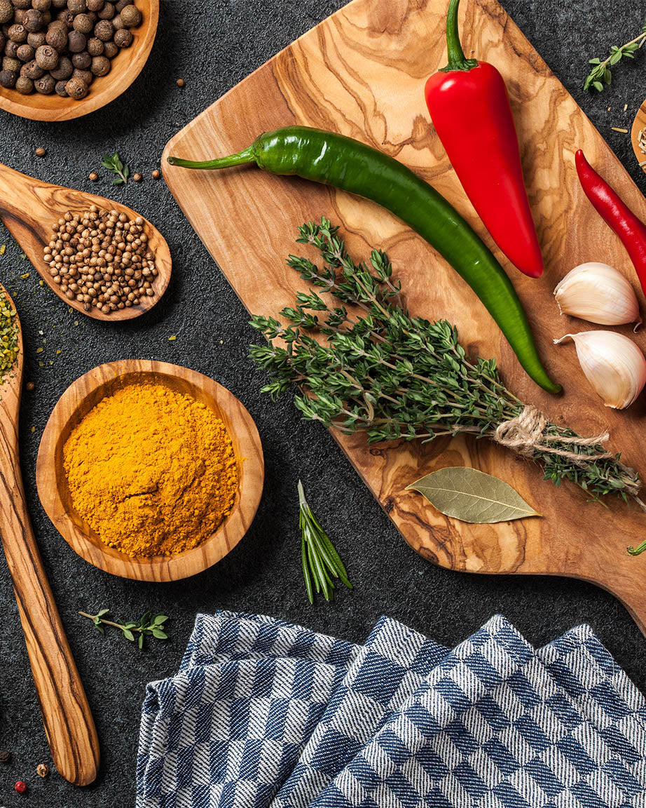 Culinary Genius Mystery Pack spices and herbs on a Cognitive Surplus wooden cutting board.
