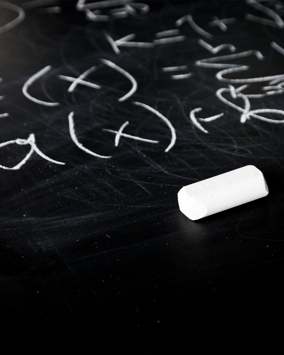 A Cognitive Surplus Equations + Calculations Mystery Pack chalk on a blackboard with numbers written on it.