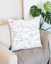 A Cognitive Surplus Lab Notes Pillow Cover with a blue and white drawing on it.