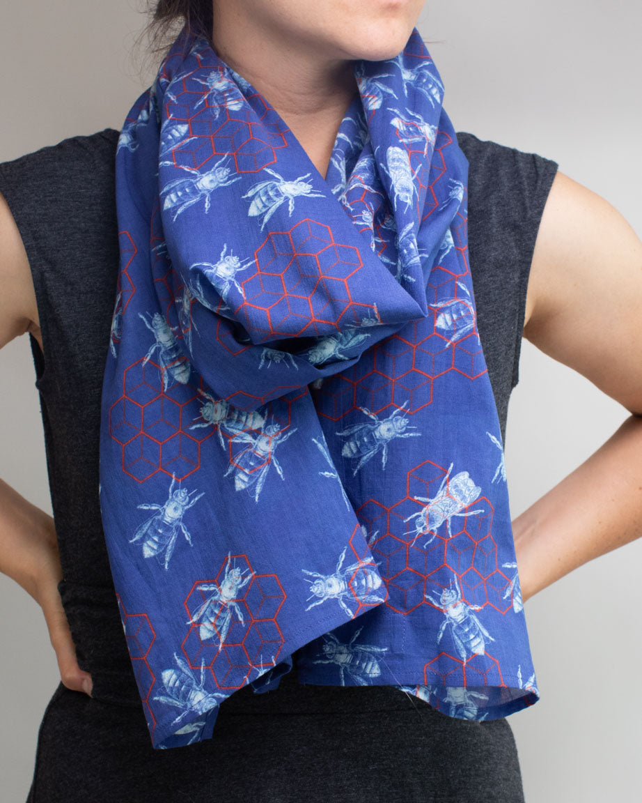 A woman wearing a blue Honey Bee Scarf by Cognitive Surplus.