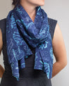 A woman wearing a Genetics & DNA Scarf by Cognitive Surplus.