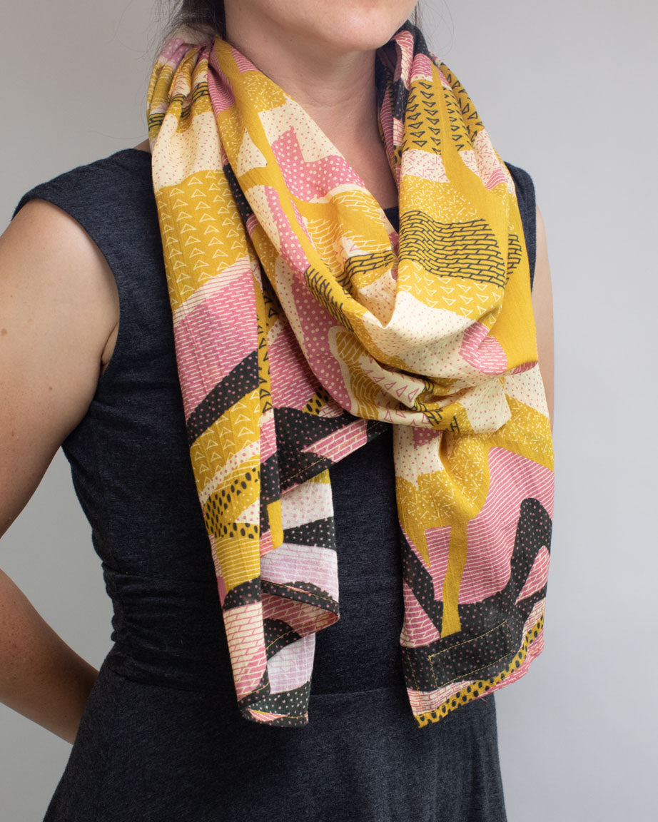 A woman wearing a Geologic Layers Scarf by Cognitive Surplus.
