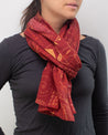 A woman wearing an Equations That Changed the World Scarf from Cognitive Surplus.