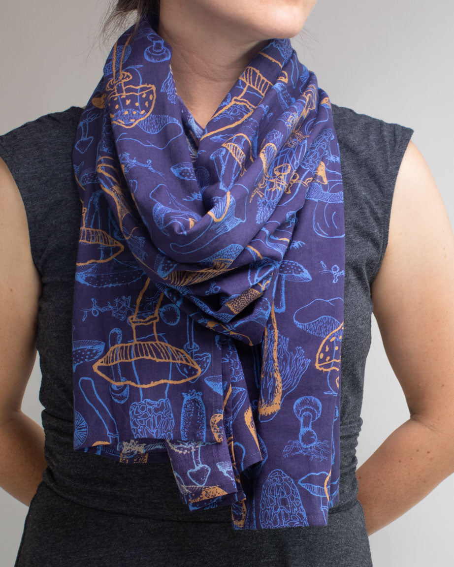 A woman wearing a Cognitive Surplus Mushroom Scarf.