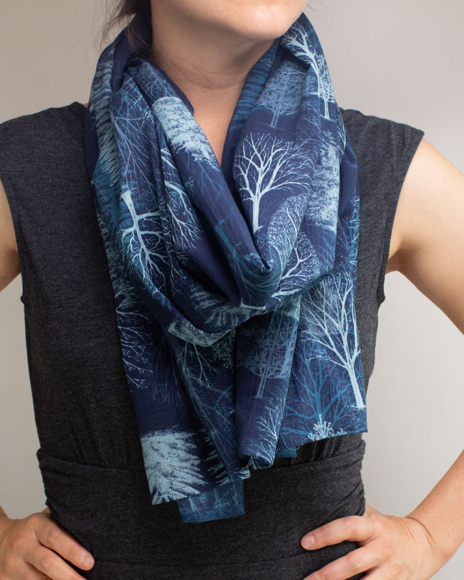 A woman wearing a Cognitive Surplus Trees & Branches Scarf.