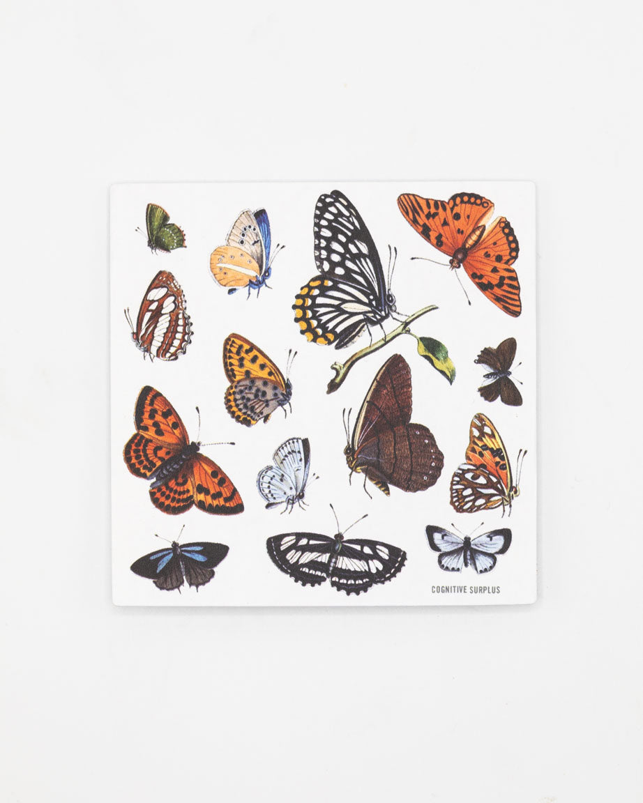 A white sheet of paper with a variety of Cognitive Surplus Butterfly Party Stickers on it.