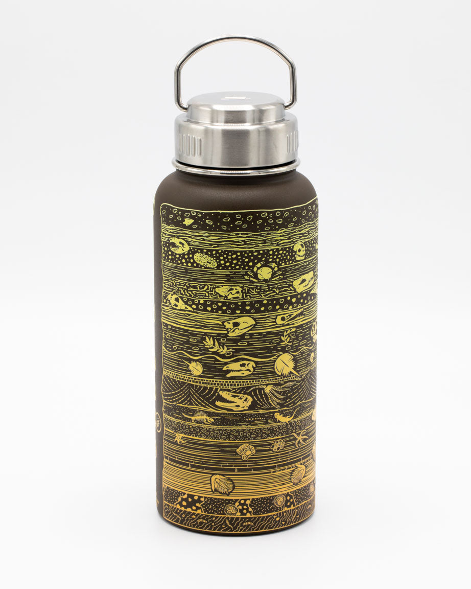 A Core Sample 32 oz Steel Bottle by Cognitive Surplus with a gold and brown design.