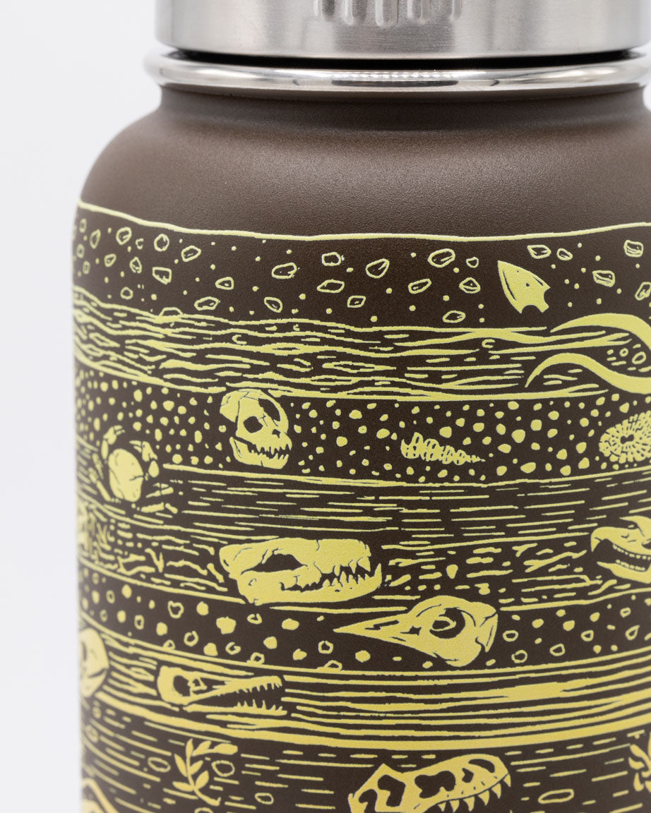 A Core Sample 32 oz Steel Bottle with a yellow design on it by Cognitive Surplus.