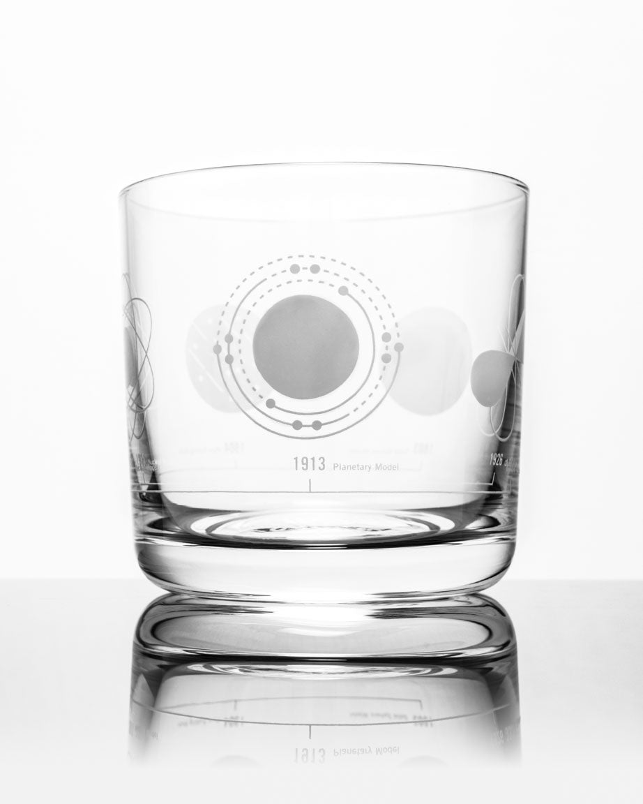 An image of the Cognitive Surplus Atomic Models Whiskey Glass with a design on it.