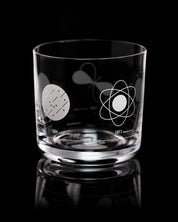 An Atomic Models Whiskey Glass with a design of atoms and stars on it by Cognitive Surplus.