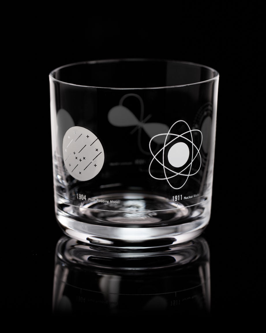 An Atomic Models Whiskey Glass with a design of atoms and stars on it by Cognitive Surplus.