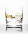 A Mountain Peaks of the World Whiskey Glass with a Cognitive Surplus mountain design on it.