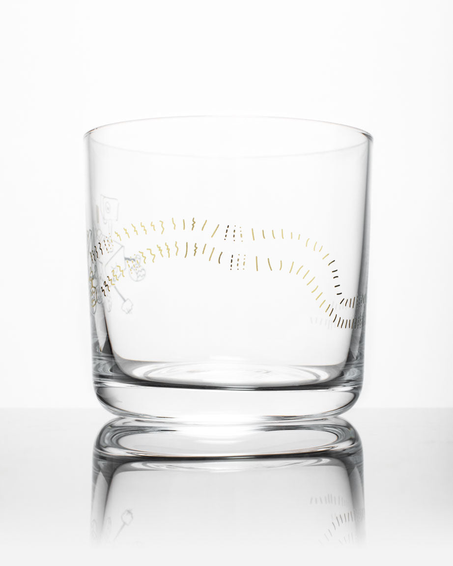 A SECONDS: Mars Rover Perseverance Whiskey Glass with a gold design on it by Cognitive Surplus.