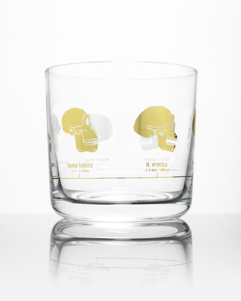 A Hominid Skulls Whiskey Glass with a Cognitive Surplus design on it.