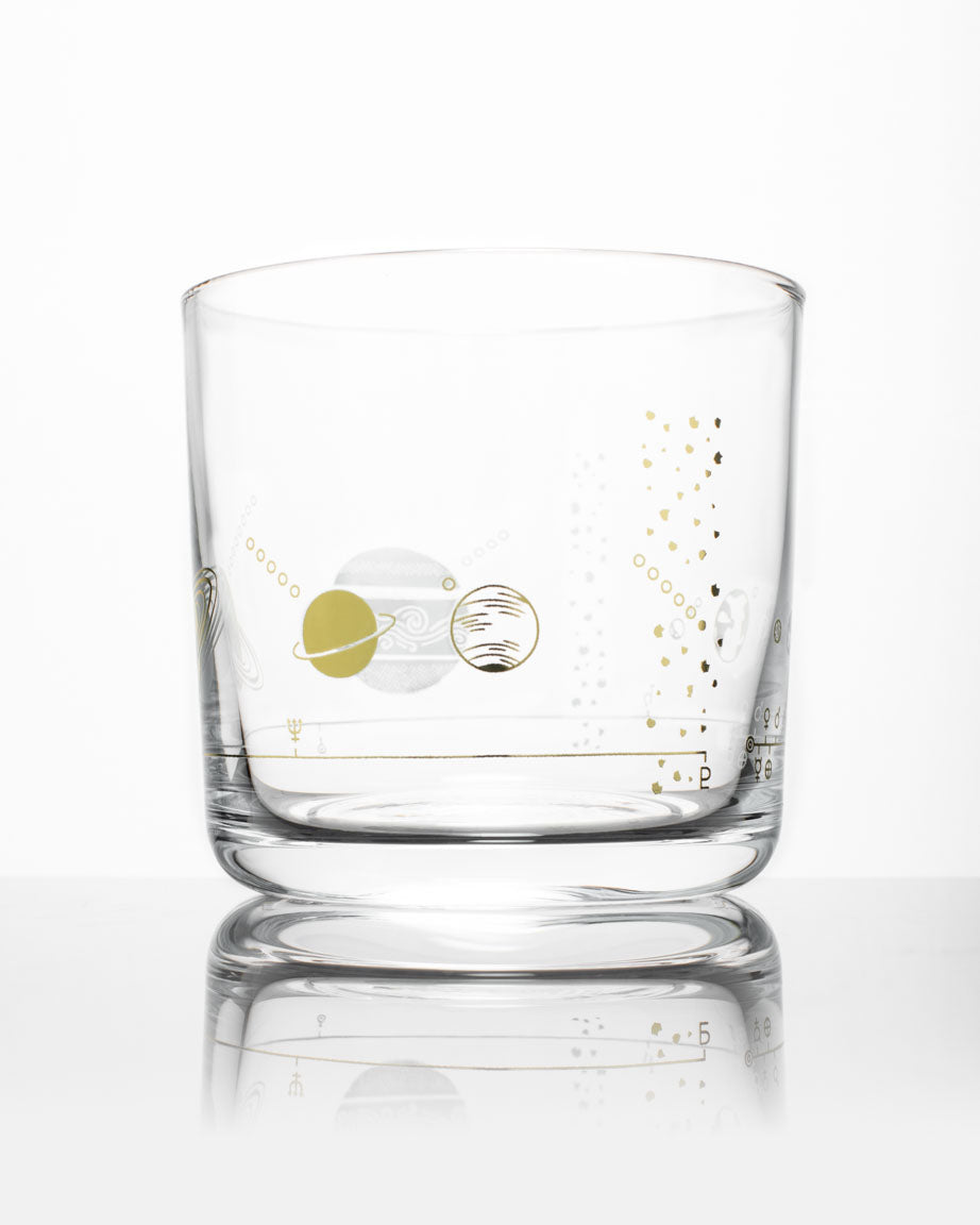 A SECONDS: Solar System Whiskey Glass with a gold and silver design on it by Cognitive Surplus.