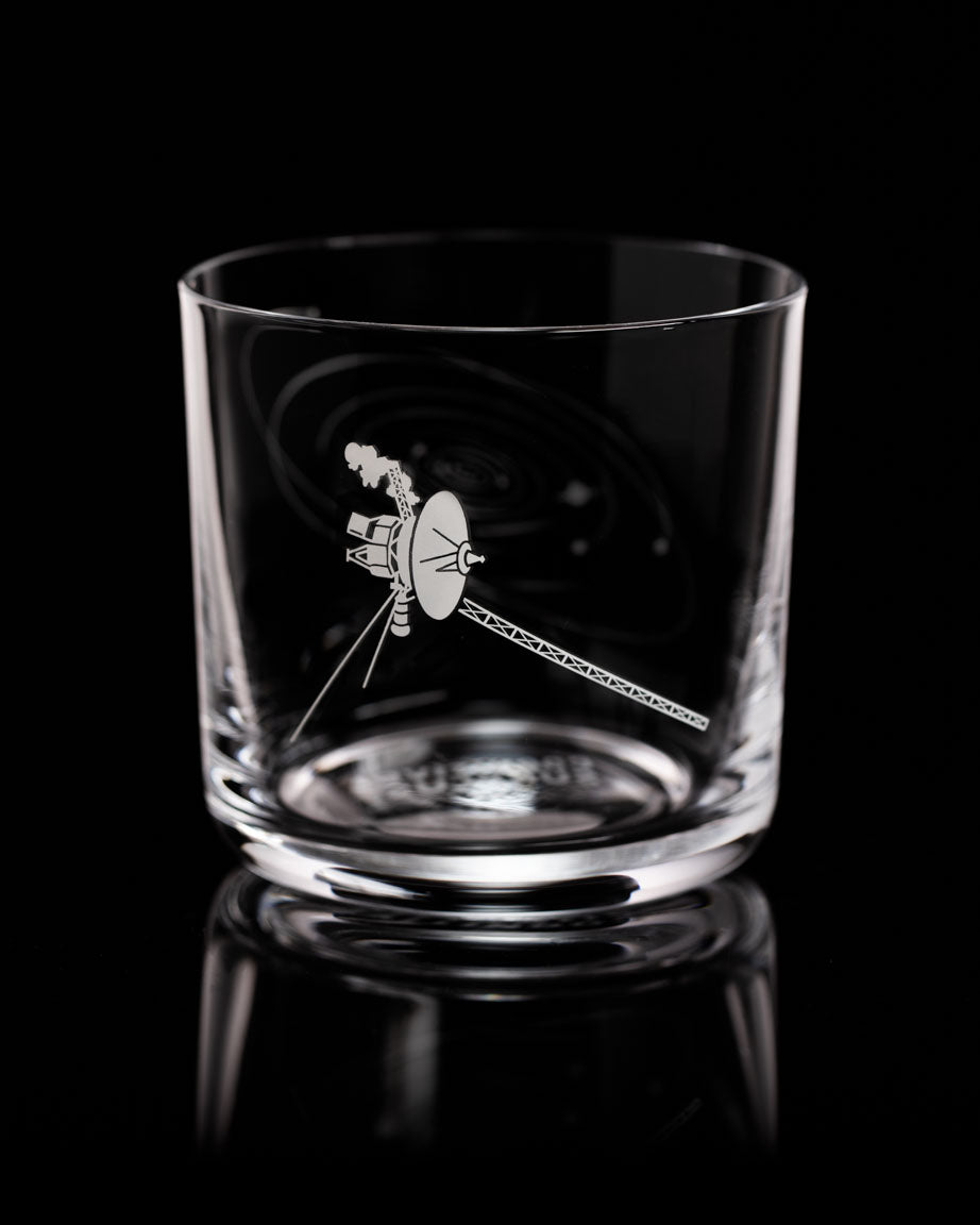 A Voyage to the Unknown Whiskey Glass with an image of a spacecraft on it, by Cognitive Surplus.