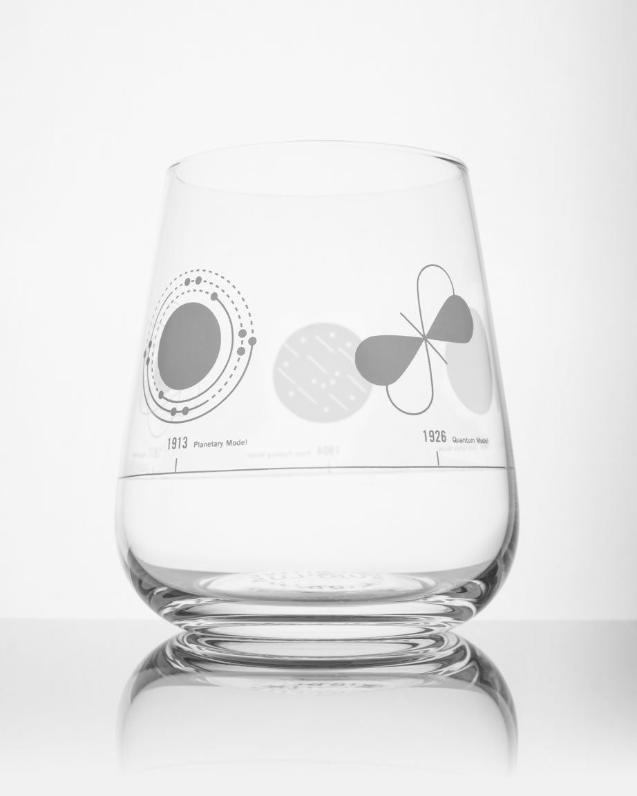 An Atomic Models Wine Glass with a design on it by Cognitive Surplus.