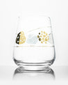 A Rock Cycle Wine Glass with a gold design on it from Cognitive Surplus.