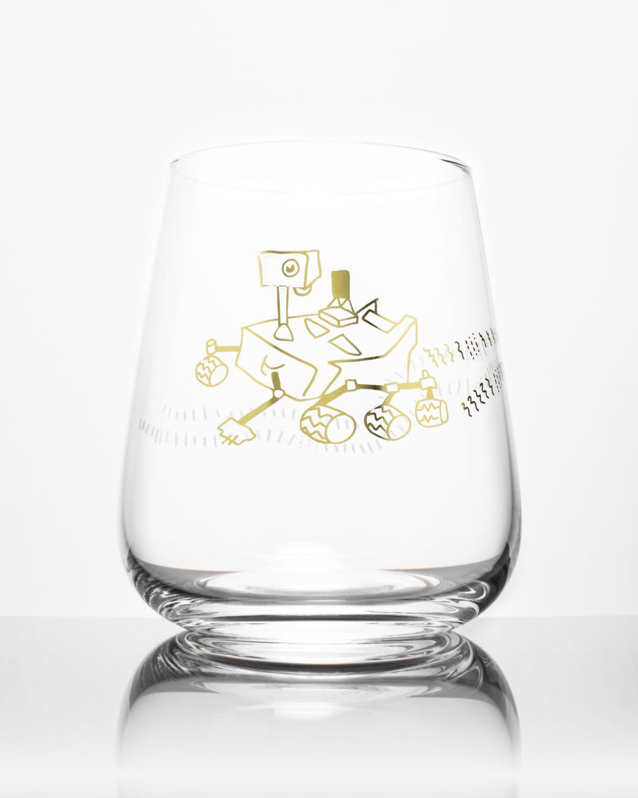A Mars Rover Perseverence Wine Glass by Cognitive Surplus with an image of a spacecraft on it.