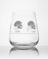 A Hominid Skulls Wine Glass by Cognitive Surplus on a white surface.